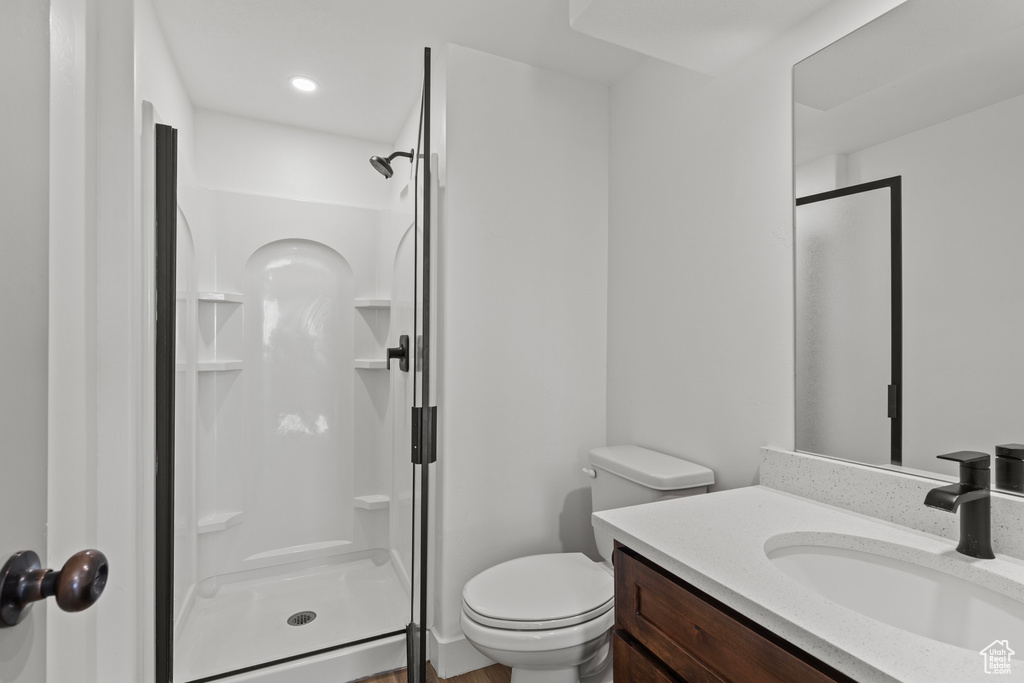 Full bath with a stall shower and vanity
