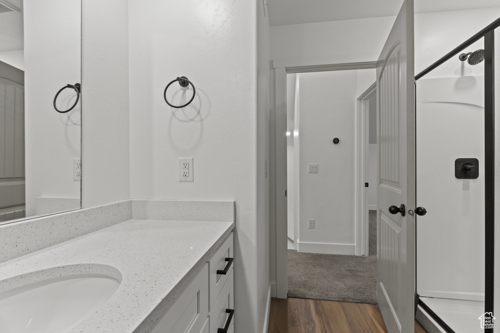 Bathroom featuring vanity and wood finished floors