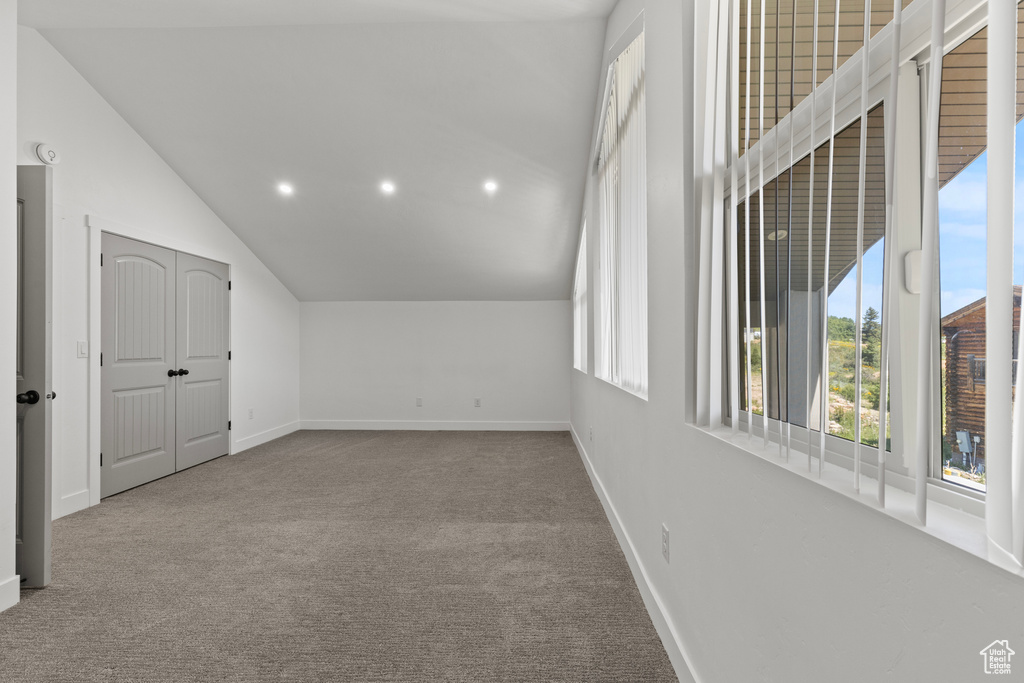 Additional living space with lofted ceiling, carpet flooring, and recessed lighting