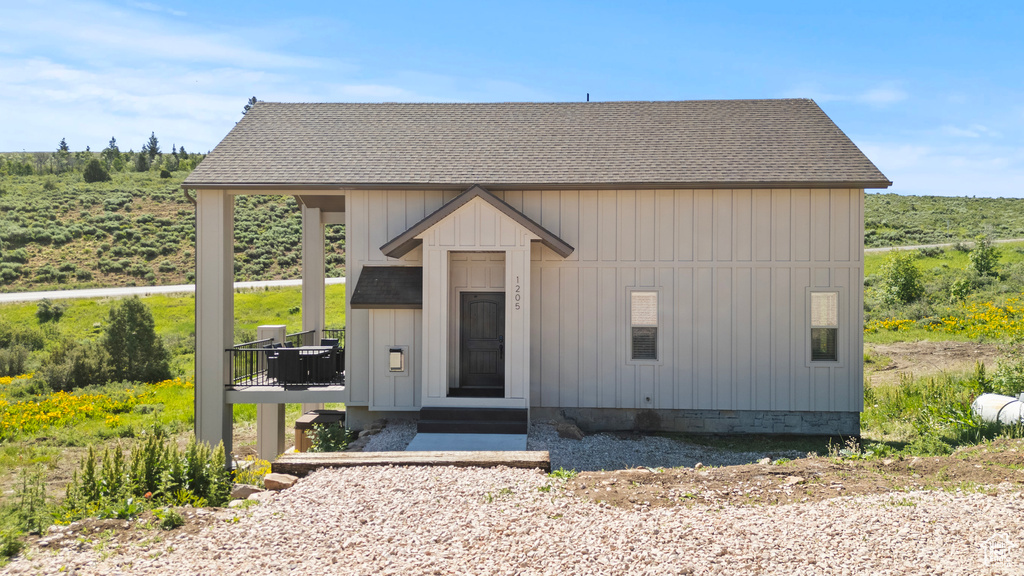 View of front of property with roof with shingles