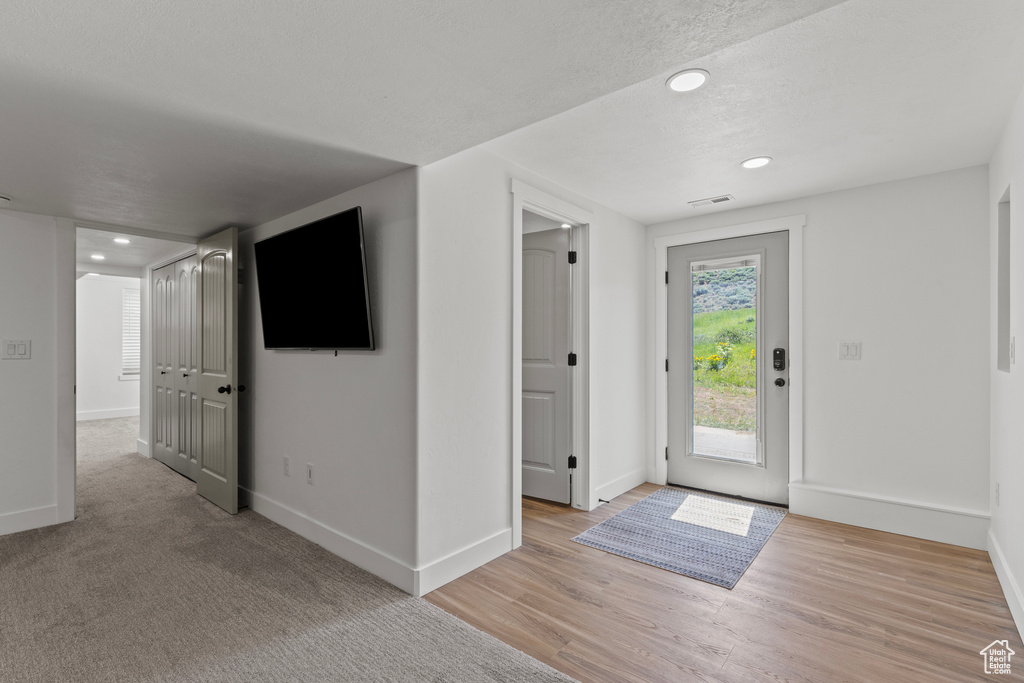 Entryway with recessed lighting and light wood-type flooring