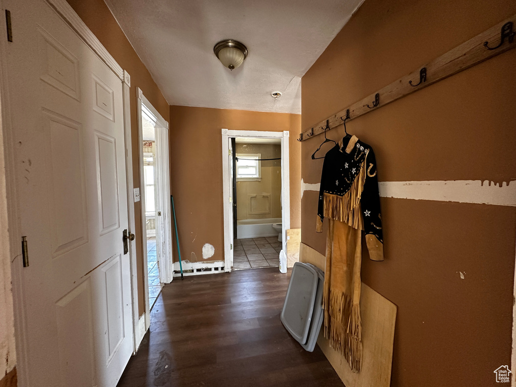 Hall with dark wood-style floors and baseboards
