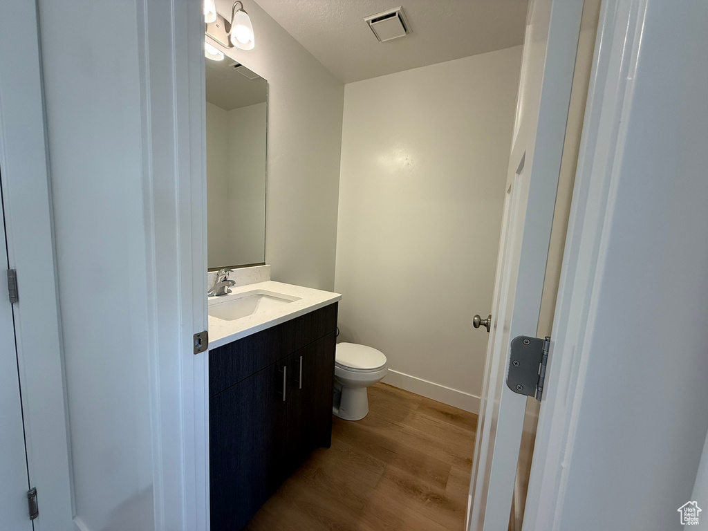 Bathroom with wood finished floors and vanity