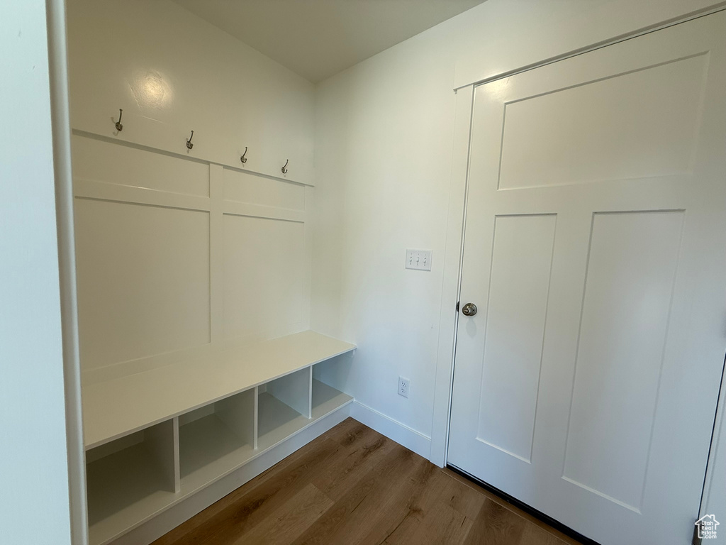 Mudroom with dark wood-type flooring and baseboards