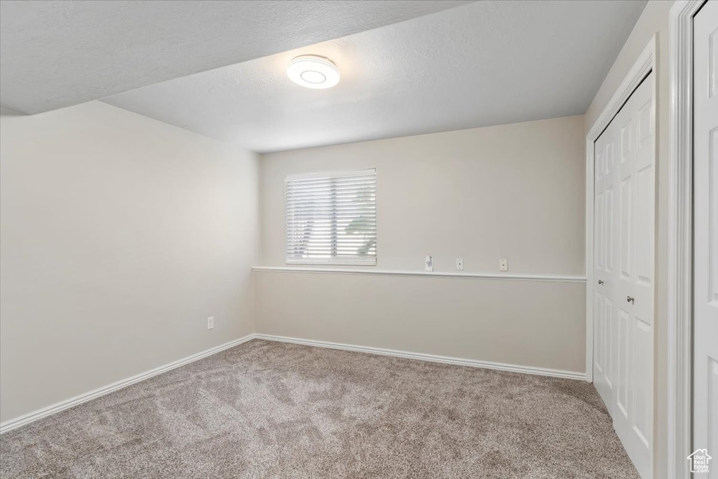 Unfurnished bedroom featuring carpet floors and a closet