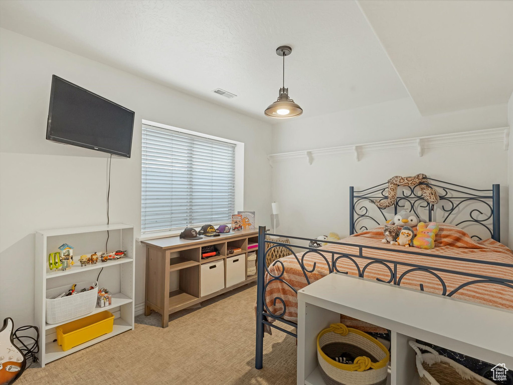 Bedroom with light colored carpet