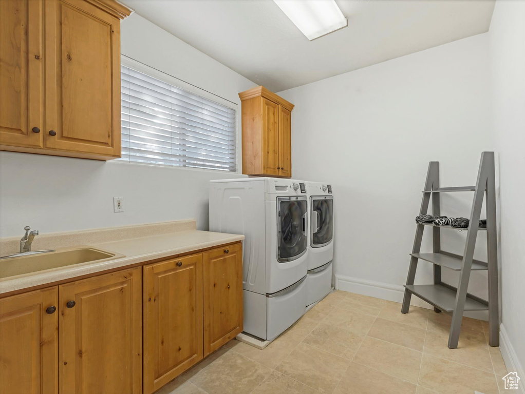 Laundry area with cabinet space and washer and clothes dryer