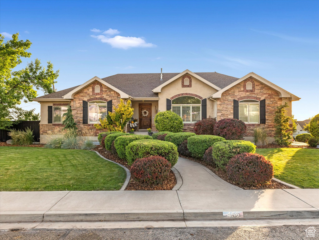 Ranch-style home with stone siding and stucco siding