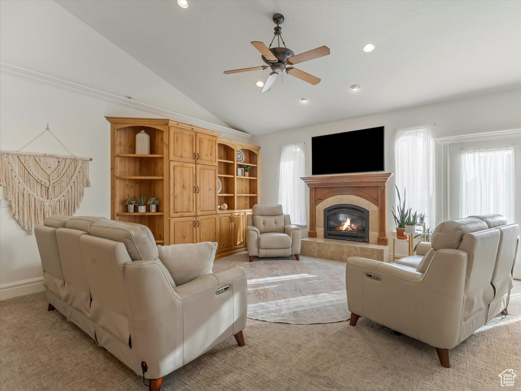 Living area with ceiling fan, lofted ceiling, light colored carpet, a tiled fireplace, and recessed lighting