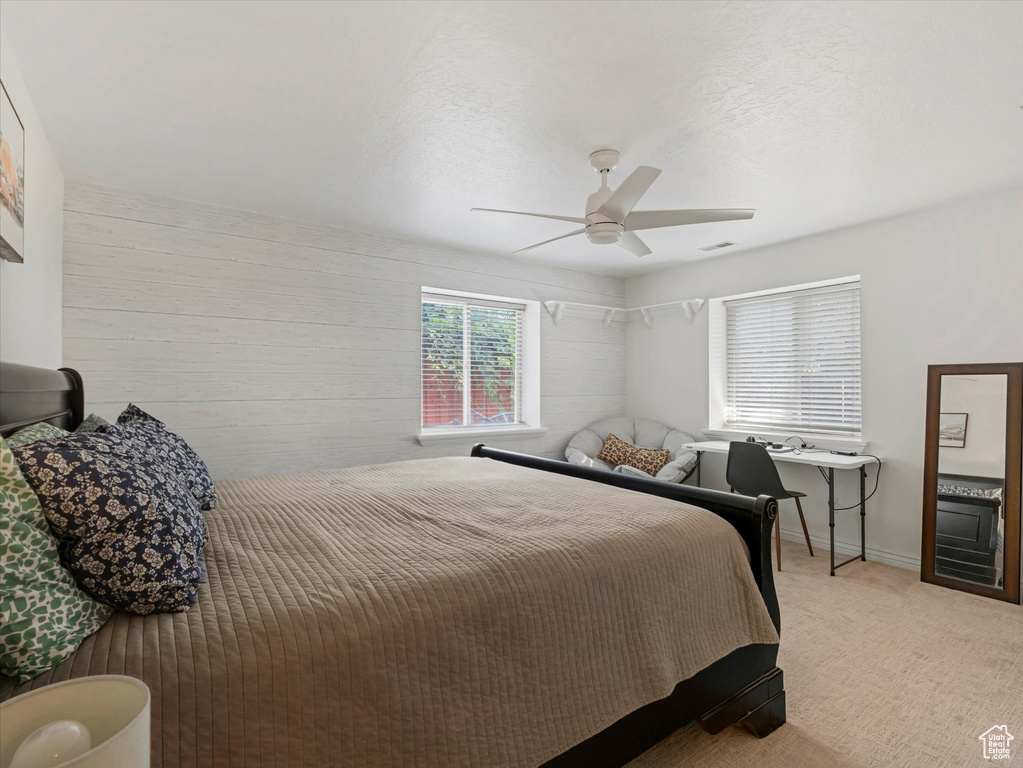 Bedroom featuring light colored carpet and a ceiling fan