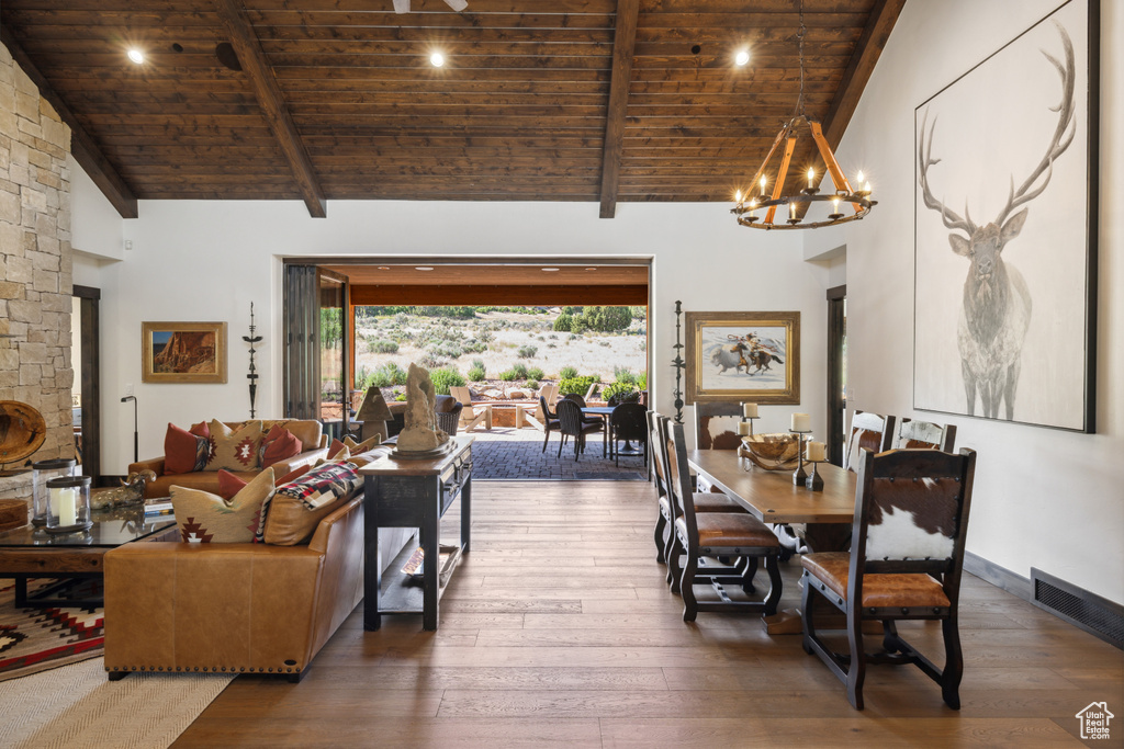Living area with a wood ceiling with exposed beams, hardwood / wood-style flooring, a chandelier, high vaulted ceiling, and recessed lighting