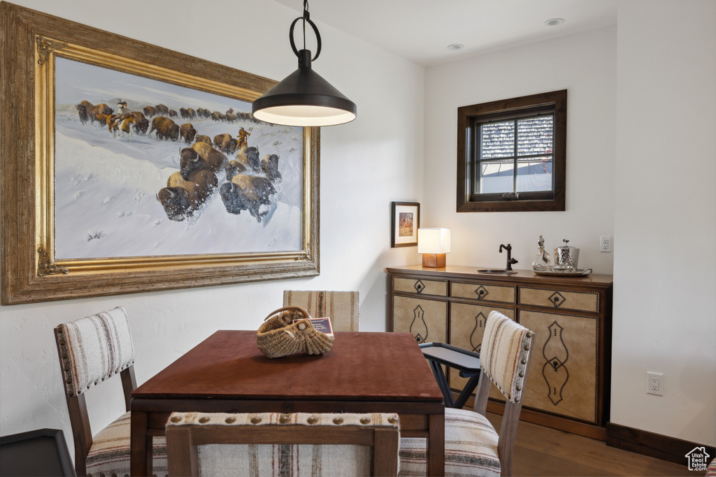 Dining space with wood finished floors and baseboards