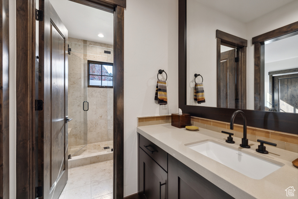 Full bath with vanity and a shower stall