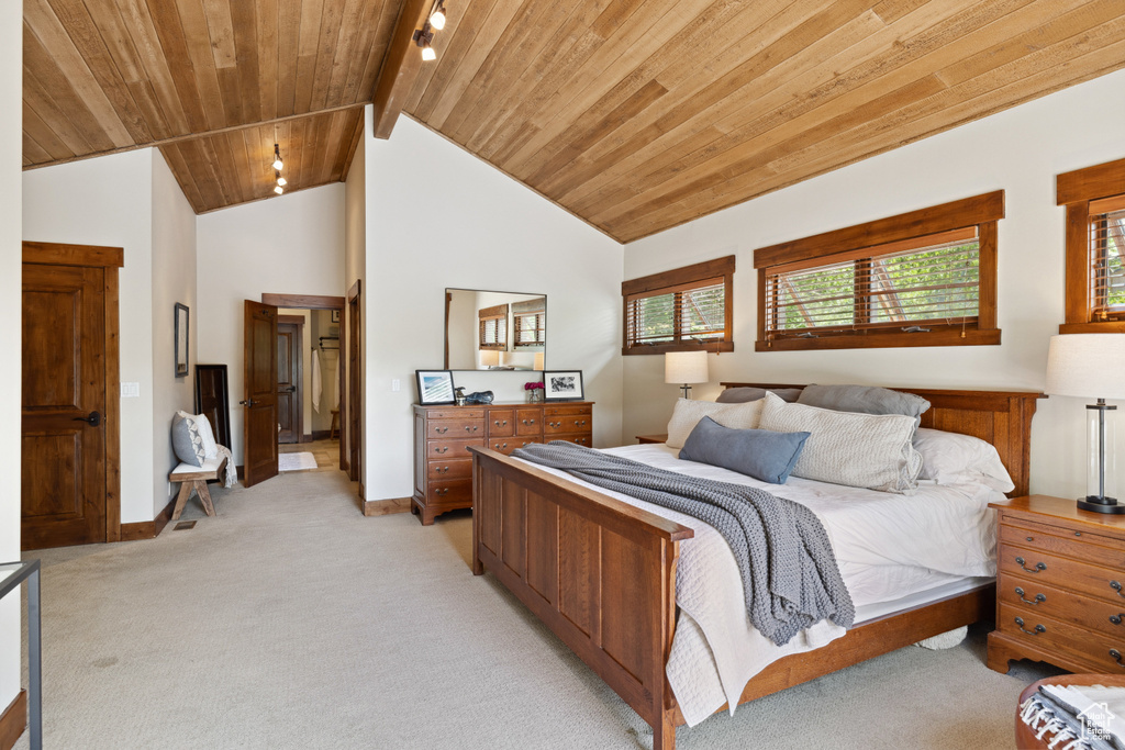 Bedroom featuring light colored carpet and wood ceiling