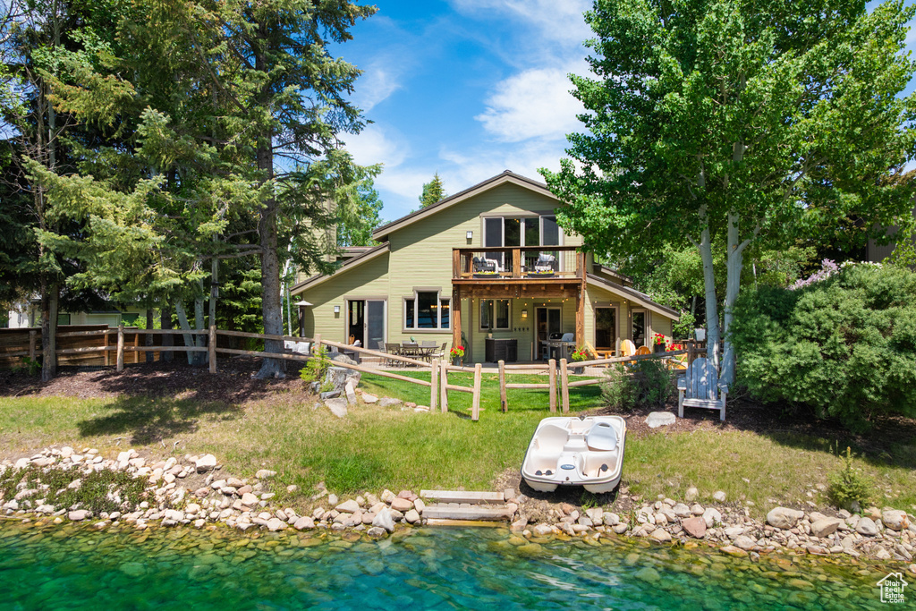 Rear view of house featuring a fenced backyard and a wooden deck