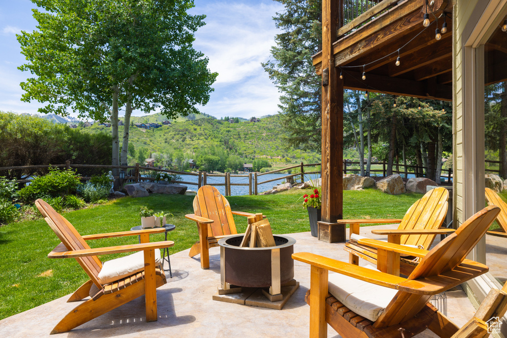 View of patio with an outdoor fire pit