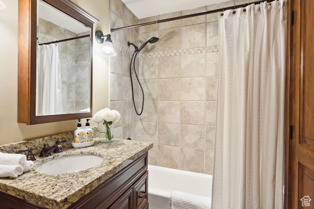 Bathroom featuring vanity and shower / bath combo