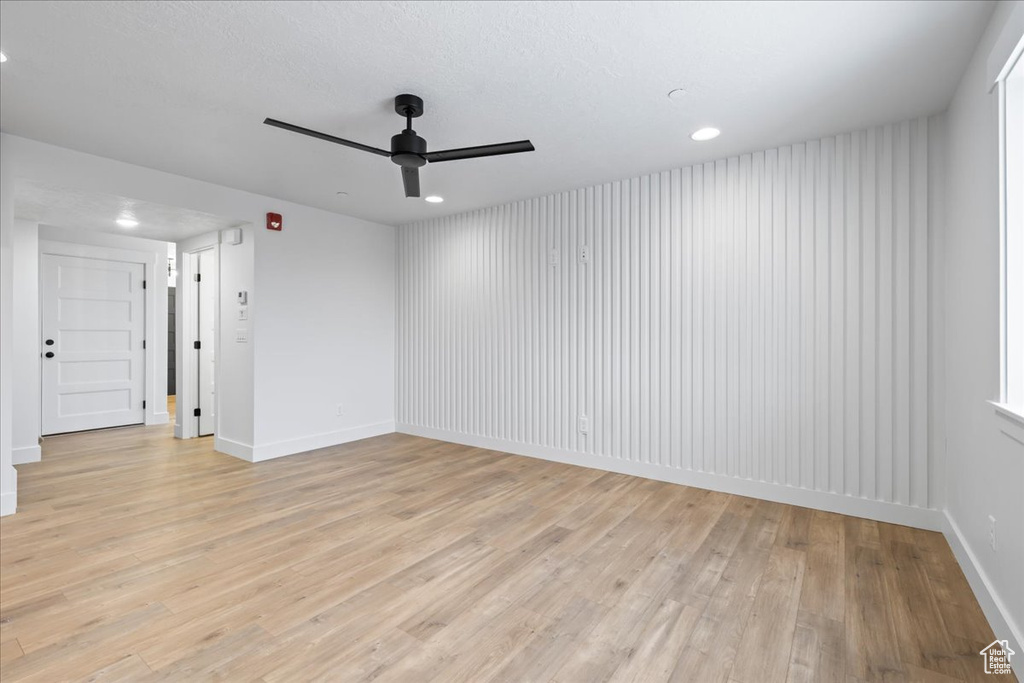 Spare room with ceiling fan, light wood-type flooring, and recessed lighting