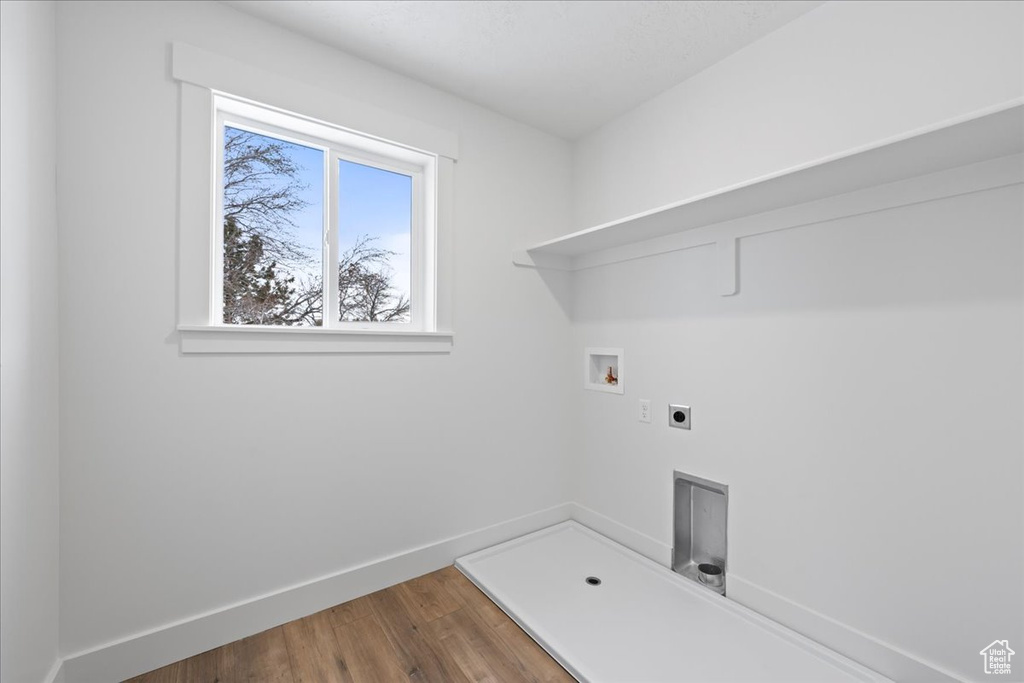 Laundry area featuring electric dryer hookup, washer hookup, and wood finished floors