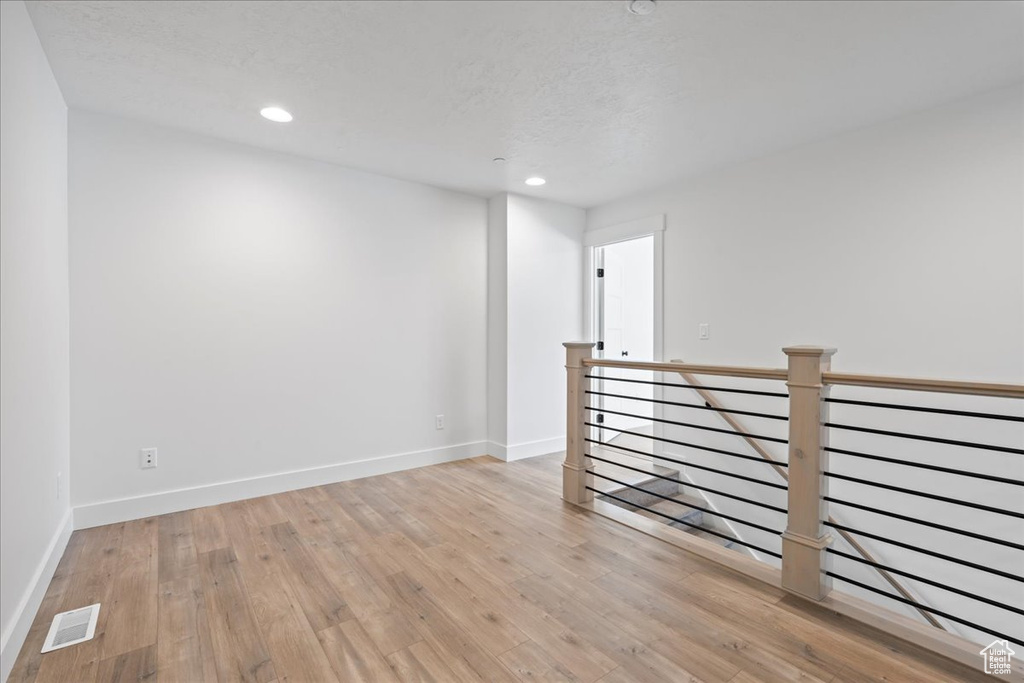 Spare room featuring light wood-style floors and recessed lighting