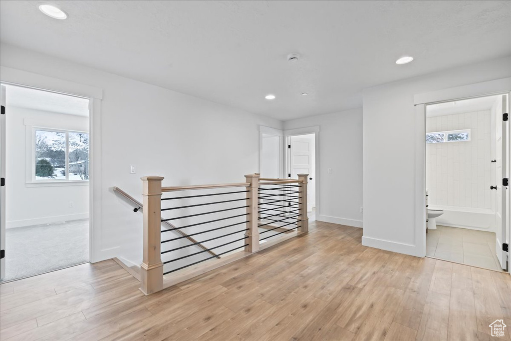 Unfurnished room with light wood-type flooring, recessed lighting, and a smoke detector