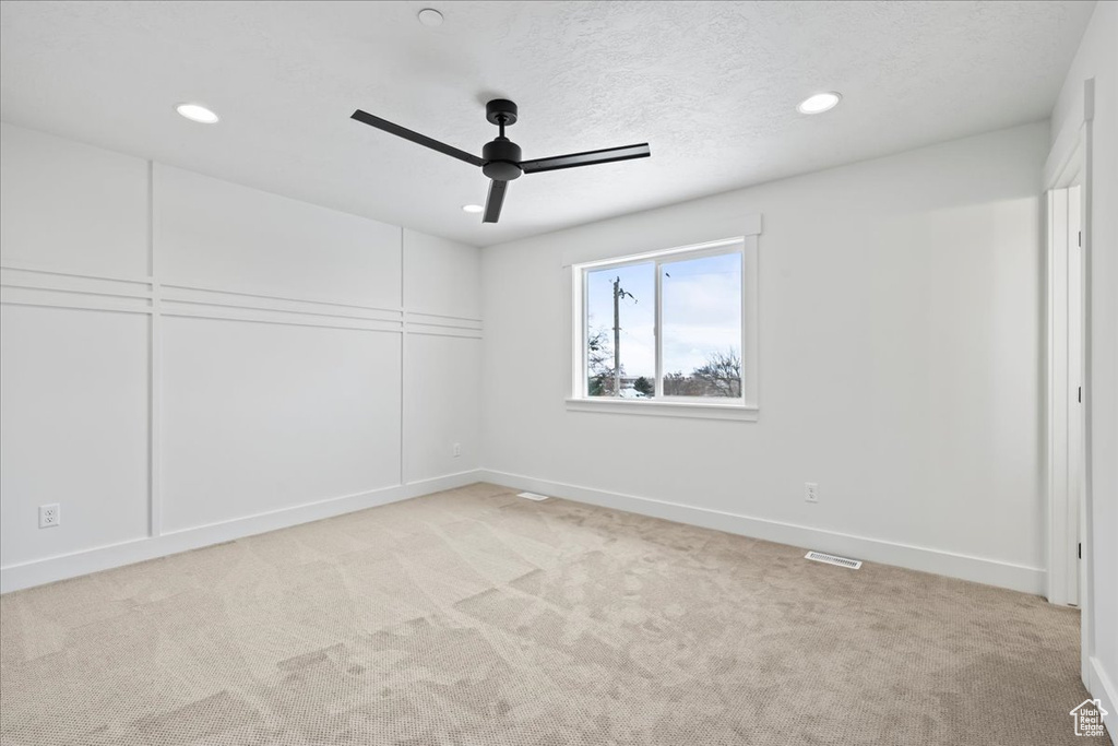 Unfurnished room featuring ceiling fan, recessed lighting, and light carpet