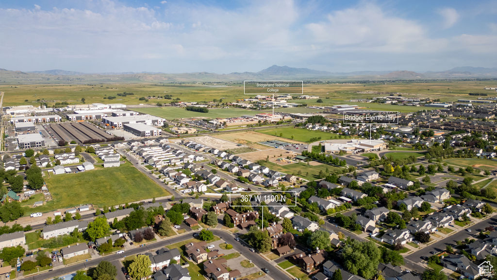 Aerial overview of property's location featuring a mountainous background