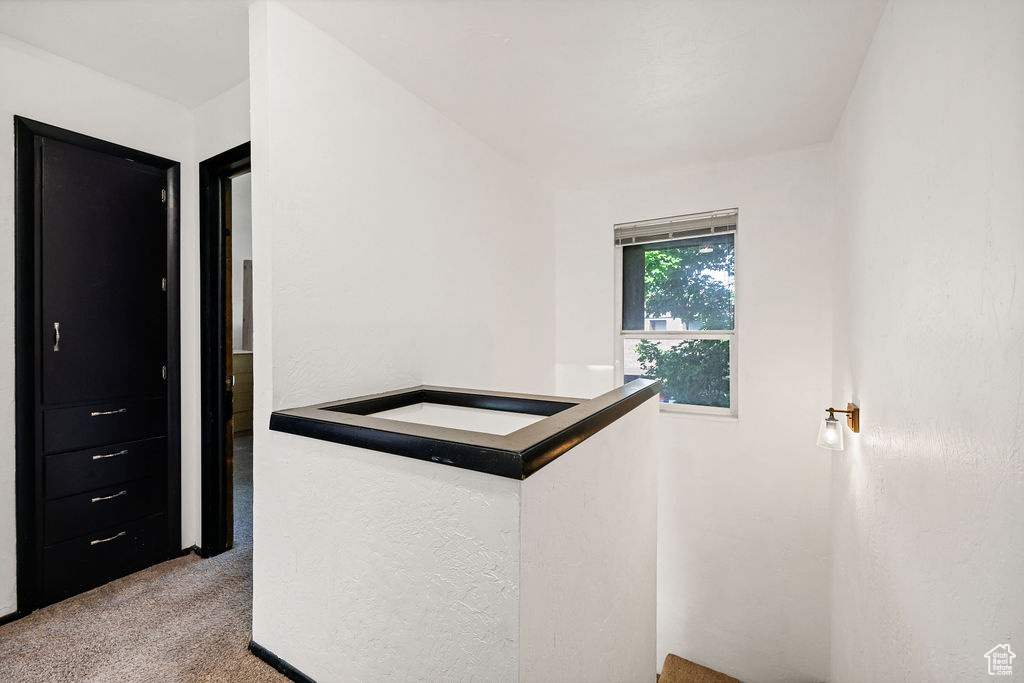 Corridor with carpet and an upstairs landing
