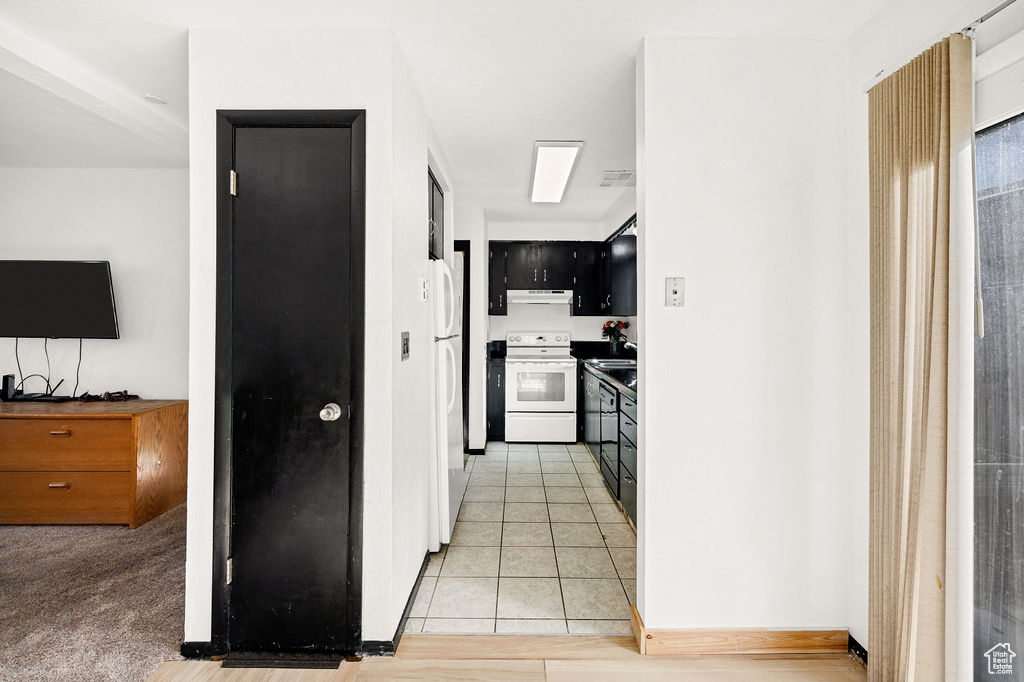 Hall featuring light tile patterned floors