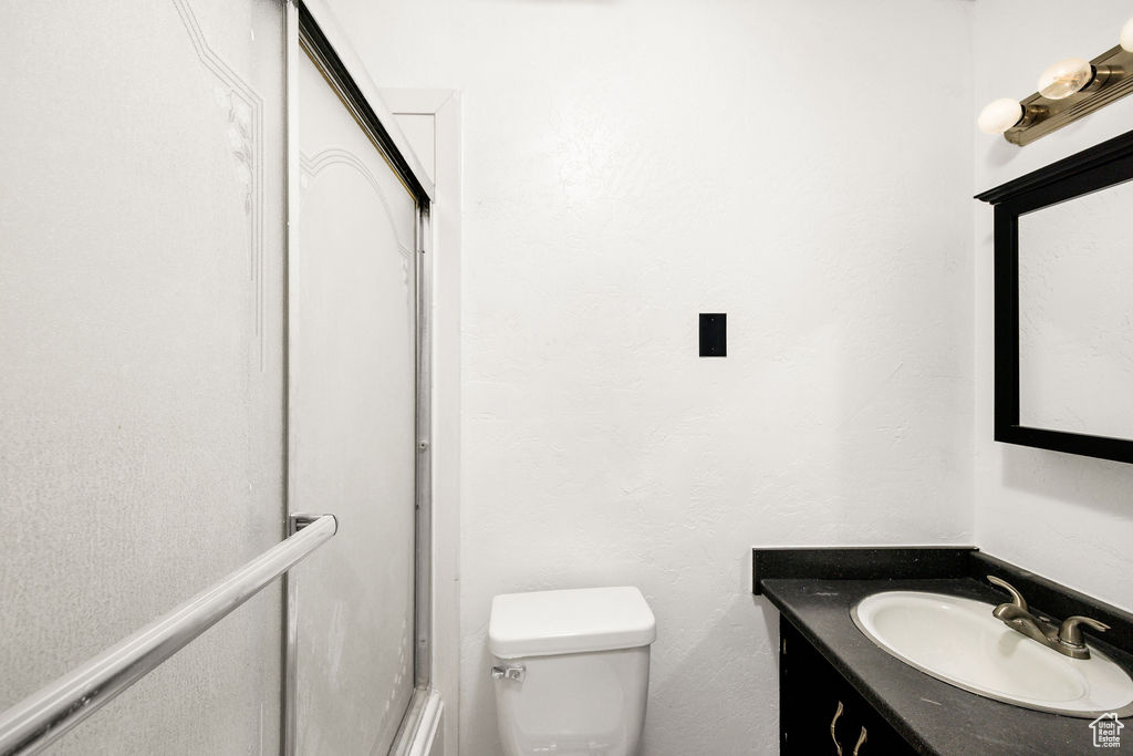 Full bathroom with vanity and toilet