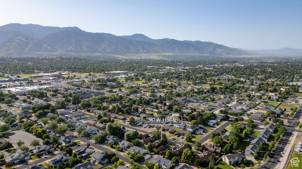 Aerial view of property and surrounding area with mountains
