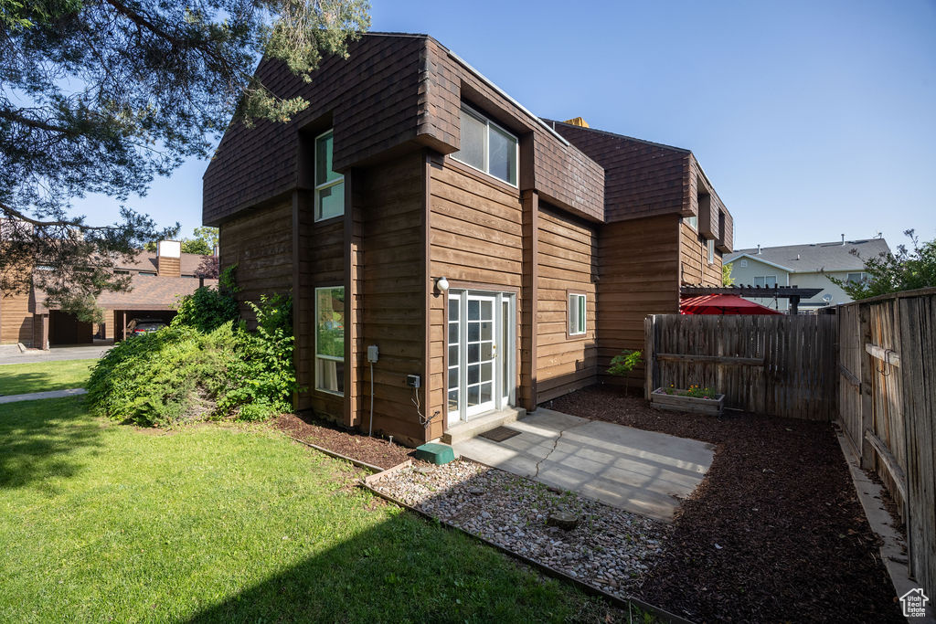 Back of property featuring roof with shingles