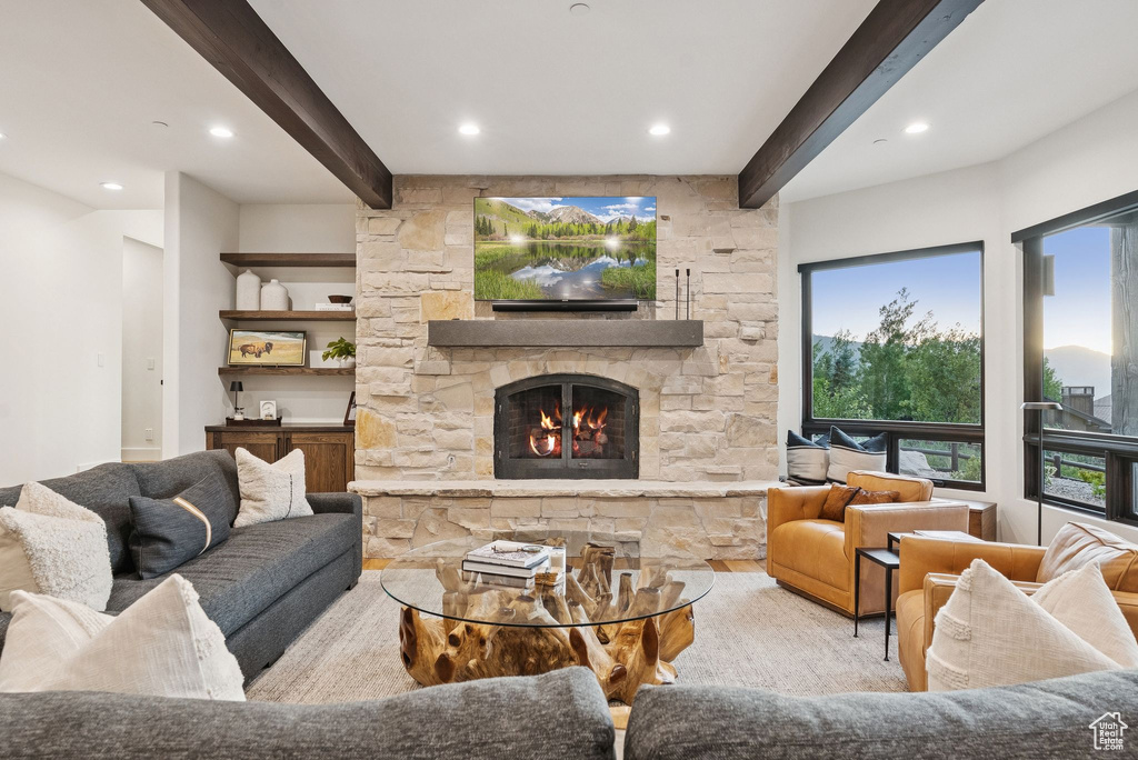 Living area with beamed ceiling, a fireplace, and recessed lighting