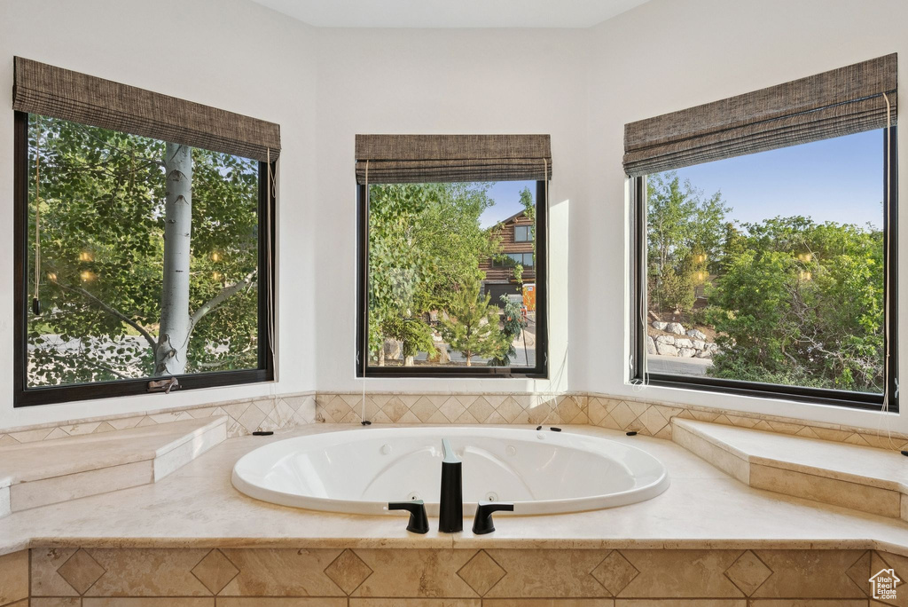 Full bathroom featuring a tub with jets