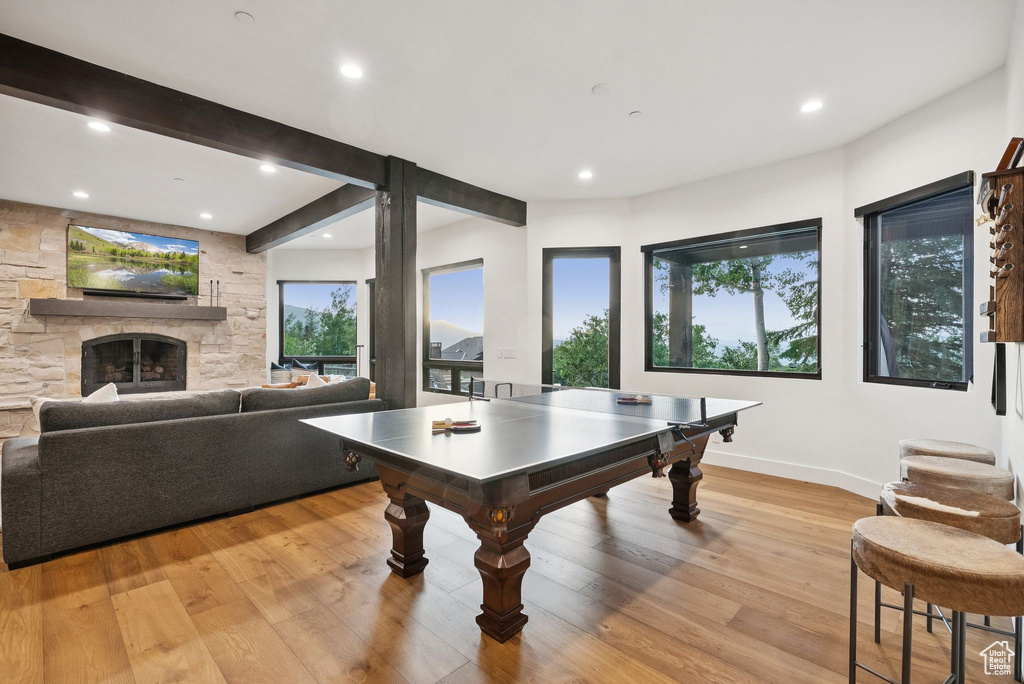 Playroom with recessed lighting, light wood-style flooring, and a fireplace