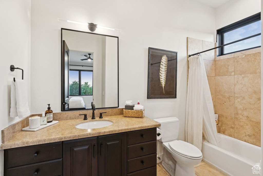 Ensuite bathroom featuring vanity and shower / bath combo with shower curtain