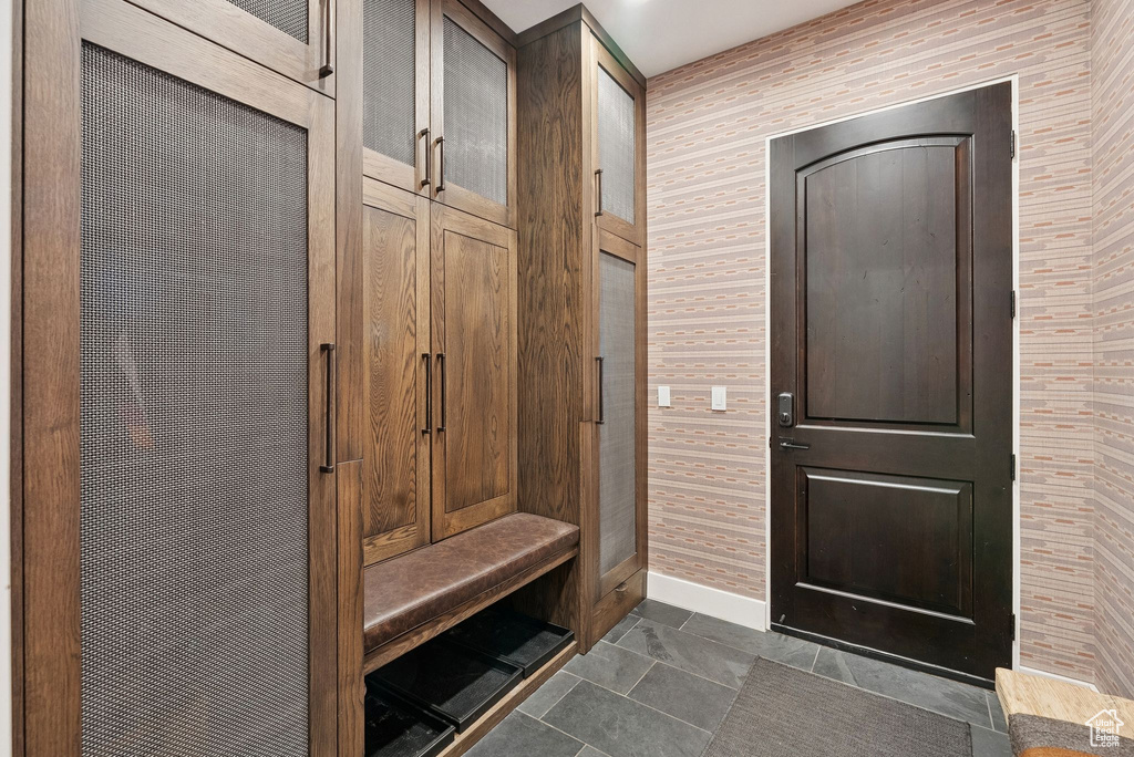 Mudroom featuring baseboards and wallpapered walls