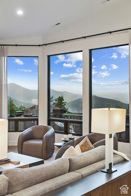 Living area featuring a mountain view, wood finished floors, and recessed lighting