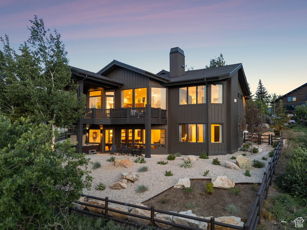 Rear view of house featuring a chimney and a patio