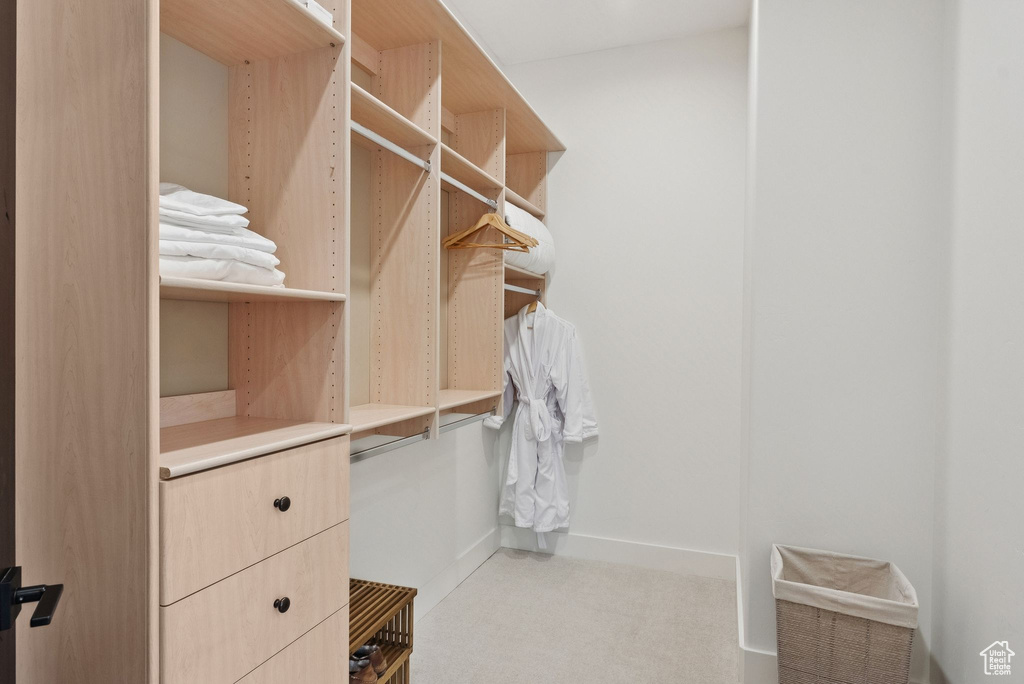 Walk in closet featuring light carpet