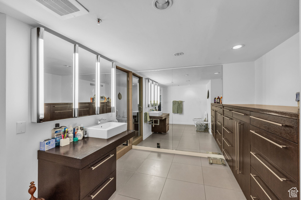 Bathroom featuring tile patterned floors, vanity, and recessed lighting