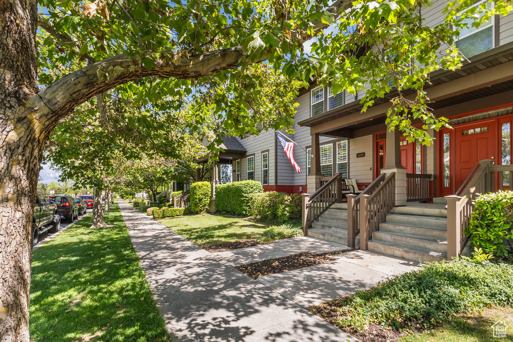 View of front of home featuring covered porch and a front lawn
