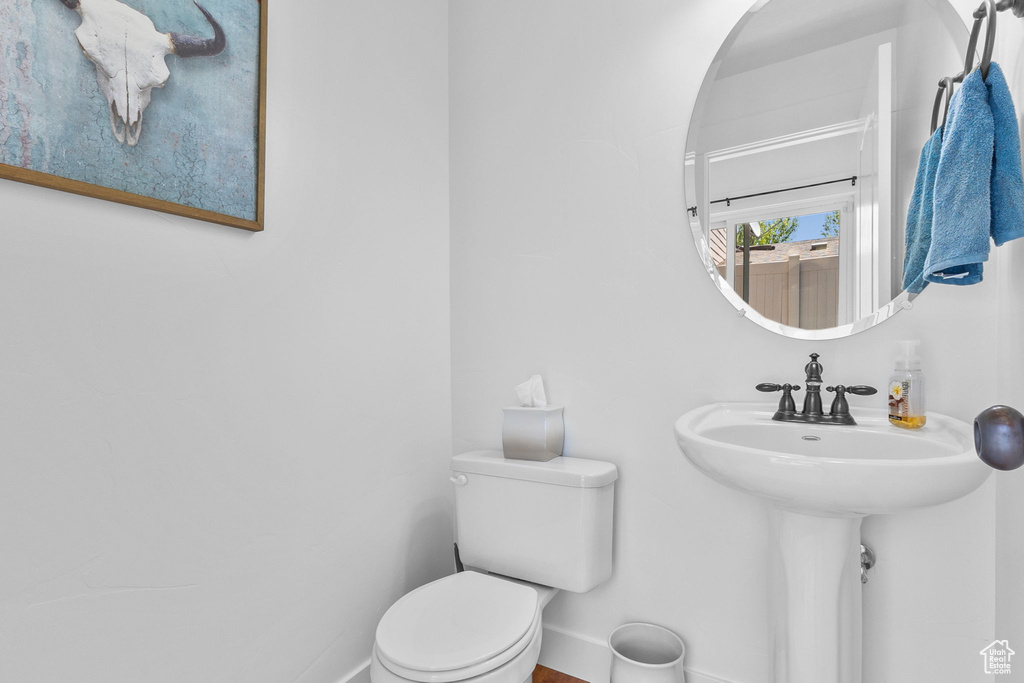 Half bath with toilet and baseboards