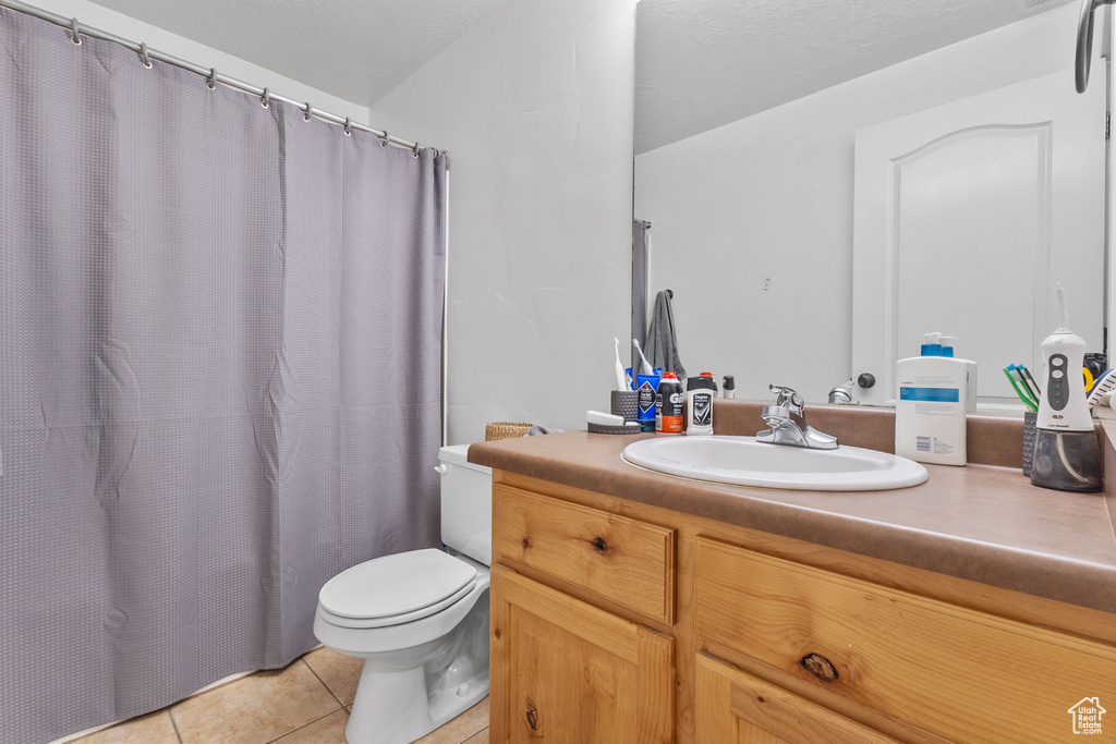 Full bath with tile patterned flooring, vanity, and a shower with curtain