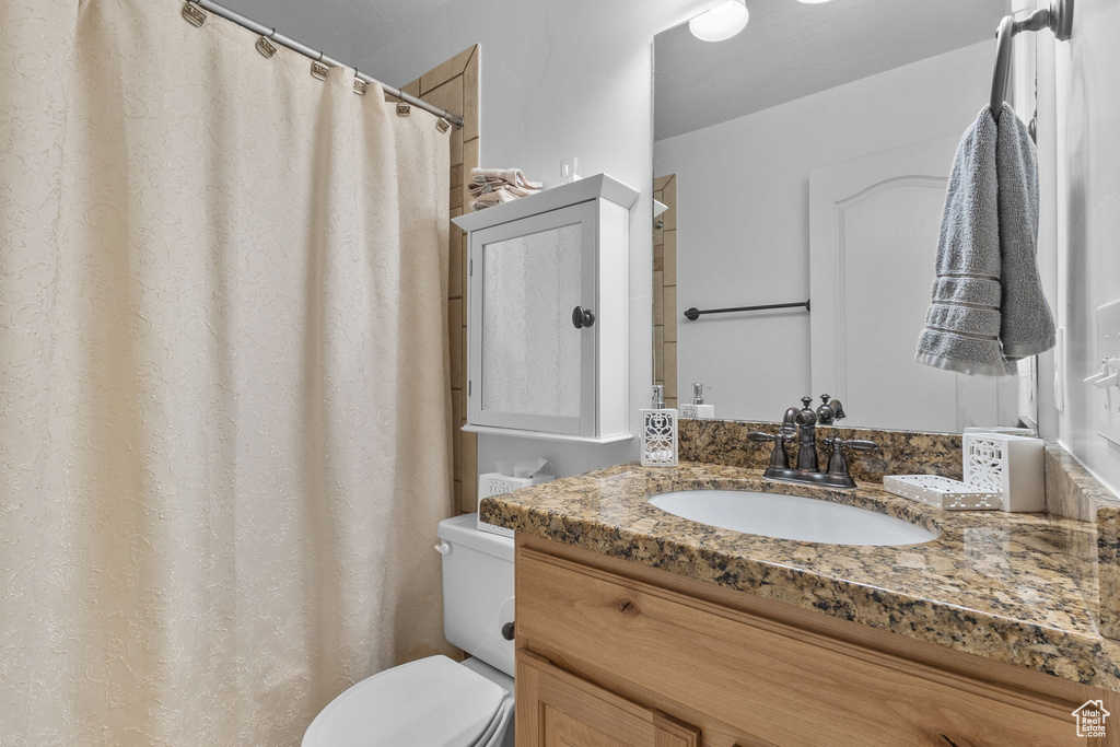 Bathroom featuring vanity and a shower with shower curtain
