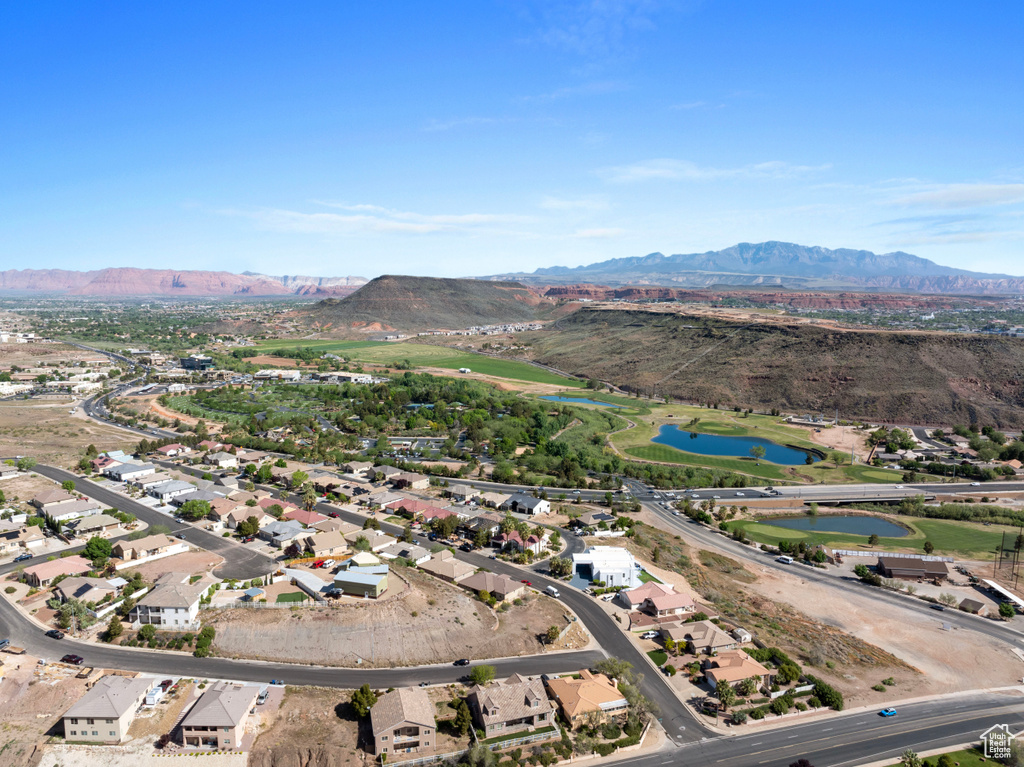 Aerial overview of property's location with a water and mountain view and nearby suburban area