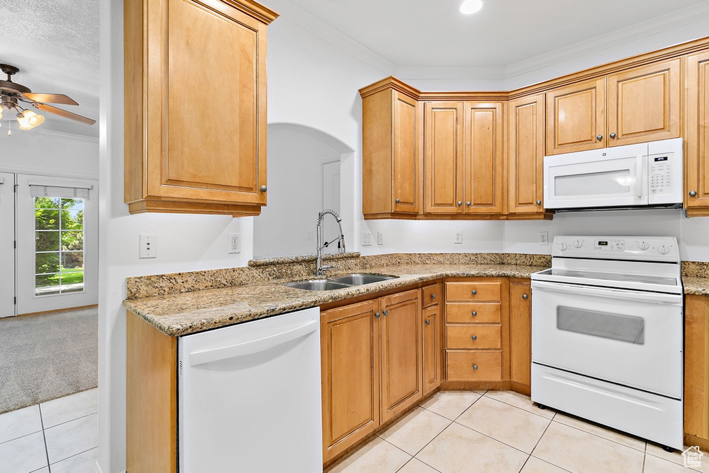 Kitchen with white appliances, light tile patterned floors, ornamental molding, a ceiling fan, and light stone countertops
