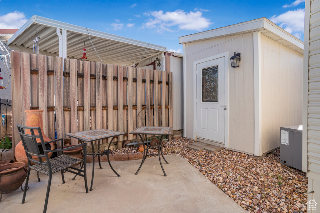 View of patio featuring a storage unit