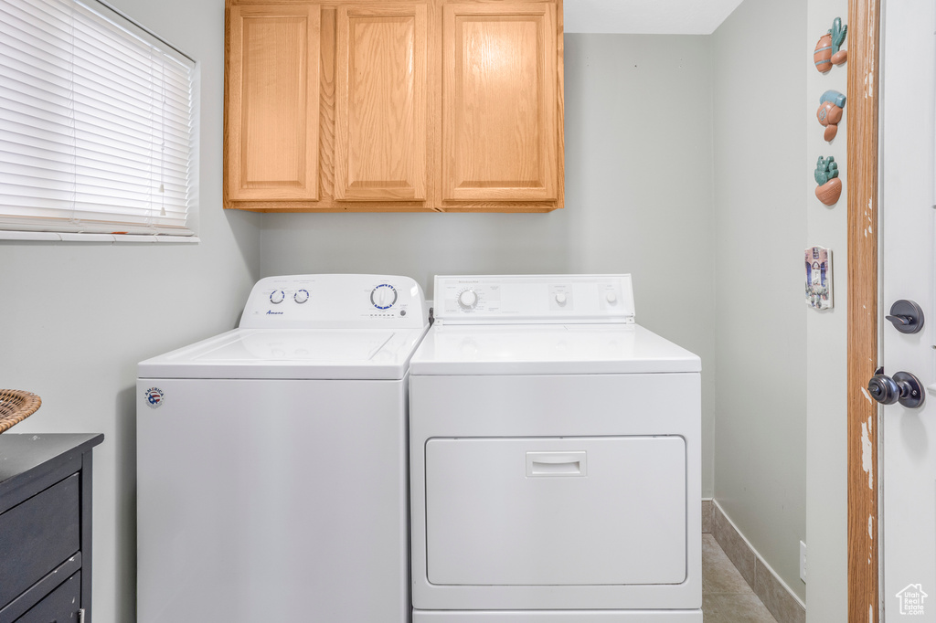 Laundry room with separate washer and dryer and cabinet space