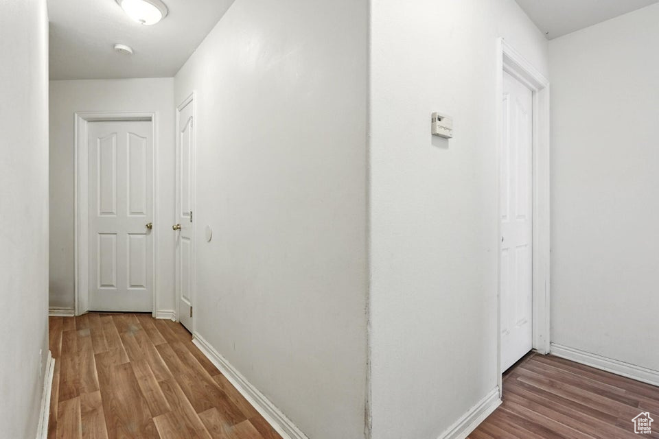 Hall featuring wood finished floors and baseboards